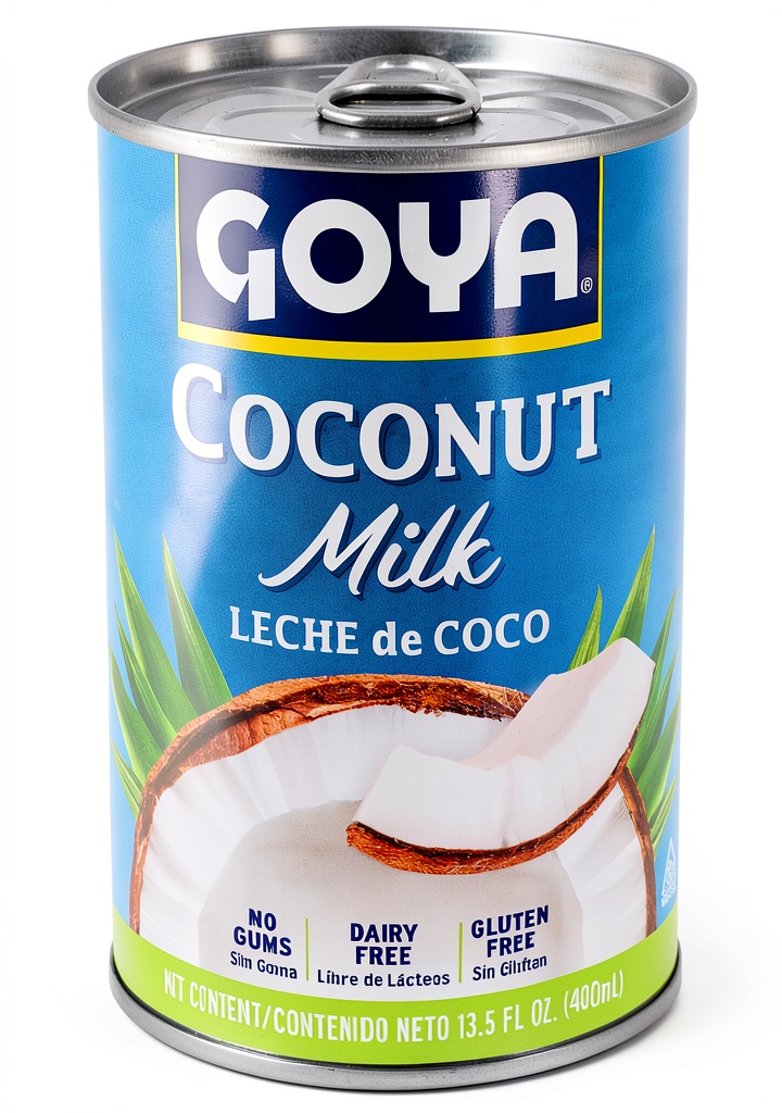 Coconut milk being poured into a saucepan for a curry